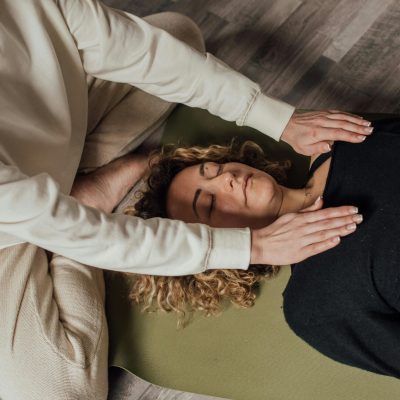 Woman in White Long Sleeve Shirt Lying on Bed